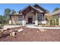 Inviting home exterior featuring a grand entrance with stone accents and professional landscaping at 5787 Powell Rd, Parker, CO 80134