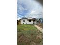 Cozy one-story home with a neatly landscaped front yard and a welcoming facade at 5030 Beach Ct, Denver, CO 80221