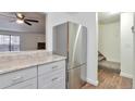 Stainless steel refrigerator and gray cabinets in updated kitchen at 9105 Oberon Rd # 2, Arvada, CO 80004