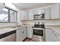 Modern kitchen with stainless steel appliances and gray cabinets at 9105 Oberon Rd # 2, Arvada, CO 80004