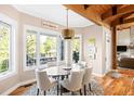 Bright dining area with large windows, stylish lighting, and seating for six at 4491 Shoshone Dr, Larkspur, CO 80118