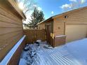 Attached garage with wooden door and brick sides at 191 S Dearborn Cir, Aurora, CO 80012