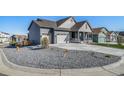 Attractive home featuring a three car garage and a well manicured front yard at 1087 E Hopkins Dr, Elizabeth, CO 80107