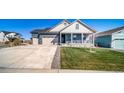 Beautiful home with a long driveway, attached garage, and covered front porch at 1087 E Hopkins Dr, Elizabeth, CO 80107
