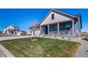 Inviting home with a well-manicured lawn and a welcoming front porch and attractive curb appeal at 1087 E Hopkins Dr, Elizabeth, CO 80107