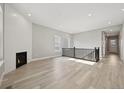 Spacious living room with hardwood floors, recessed lighting, and a sleek fireplace at 5905 S Platte Canyon Dr, Littleton, CO 80123