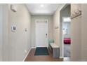 Bright foyer with a coat rack and a bench; the front door lets in ample light and creates a welcoming space at 26909 E Cedar Ave, Aurora, CO 80018