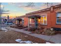 Brick row house with a charming covered porch, showcasing classic architectural details at 1235 31St St, Denver, CO 80205