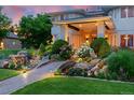 Close-up of the landscaped front yard and stone walkway with a bridge over a tranquil water feature at 7 Sandpiper Cir, Thornton, CO 80241