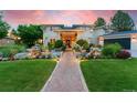 Beautiful home with a lush landscaped yard, a stone walkway, and a charming water feature at 7 Sandpiper Cir, Thornton, CO 80241