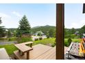 View from the porch, highlighting the greenery, landscaping and mountain views at 3257 Sun Ridge Ln, Evergreen, CO 80439