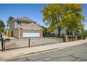 A well-maintained home featuring brick accents, a two-car garage, and a secure gated entrance at 5419 E 113Th Ave, Thornton, CO 80233
