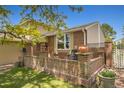 Relaxing brick patio featuring ample seating space surrounded by beautiful landscaping and privacy fencing at 5419 E 113Th Ave, Thornton, CO 80233