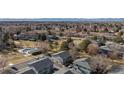 Aerial view of a well-maintained community featuring townhomes, green spaces, mature trees, and community pool at 1223 S Wheeling Way, Aurora, CO 80012