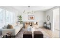 Bright living room featuring a comfy sofa and stylish armchairs at 7154 S Hudson Cir, Centennial, CO 80122