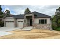 Inviting single-story residence featuring a stone facade, gray siding, and a neatly landscaped front at 6152 Powell Rd, Parker, CO 80134