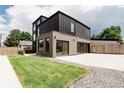 Stunning modern home with unique architectural design, a lush lawn, and an attached garage at 2040 W 45Th Ave, Denver, CO 80211