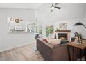 Open-concept living room with a fireplace, sliding glass door access to a balcony, and views to the kitchen at 6755 S Field St # 625, Littleton, CO 80128