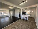 Open-concept living space boasts hardwood floors and a kitchen island with stool seating at 10555 Montview Blvd, Aurora, CO 80010
