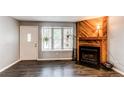 Cozy living room featuring a modern fireplace, large windows, and ample natural light at 1128 S Ventura Cir # K, Aurora, CO 80017