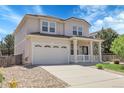 Two-story home with a two-car garage, front porch, and neutral-colored exterior with manicured lawn at 2354 Cactus Bloom Ct, Castle Rock, CO 80109