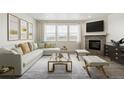 A spacious living room with a fireplace, large windows, comfortable seating, and stylish decor at 1884 Sawtooth Mountain Dr, Berthoud, CO 80513