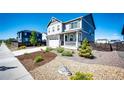 Lovely home with rock landscaping, front porch, and a two-car garage at 129 S Waterloo St, Aurora, CO 80018