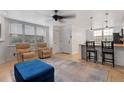 Open concept living space with tile floors, comfortable seating, and a view of the kitchen area at 5765 W Atlantic Pl # 104, Lakewood, CO 80227