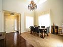 Dining area with a wooden table, seating for six, a chandelier, and hardwood floors at 5626 S Biloxi Way, Aurora, CO 80016