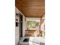 Inviting porch with swing, 'hello' rug, and wood ceiling detail at 1061 Adams St, Denver, CO 80206