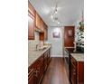 Galley kitchen has granite counters, stainless appliances and wood cabinets at 1233 N Ogden St # 610, Denver, CO 80218