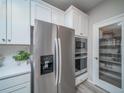 Close-up of the kitchen's stainless steel refrigerator, microwave, oven and walk-in pantry at 21947 E 51St Dr, Aurora, CO 80019