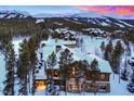 Luxury home in snowy mountain setting at sunset at 457 Timber Trail Rd, Breckenridge, CO 80424