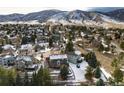 Scenic aerial view of the community showcasing mountain views, mature trees, and snow-dusted rooftops on an overcast day at 6 White Alder, Littleton, CO 80127