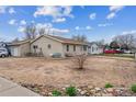 This single story home has a large front yard and a detached garage at 1418 5Th St, Fort Lupton, CO 80621