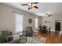Inviting living room with hardwood floors, a ceiling fan and stylish decor creating a comfortable and welcoming atmosphere at 2415 Chase St, Edgewater, CO 80214
