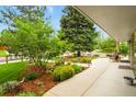 Inviting front porch with lush landscaping and mature trees overlooking the street at 403 Anderson St, Castle Rock, CO 80104