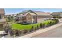 Spacious backyard with lush green lawn, privacy fence, and large back porch deck at 22891 E Union Cir, Aurora, CO 80015