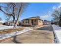 Brick ranch home with a large yard and detached garage at 2584 S Utica St, Denver, CO 80219