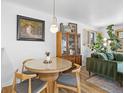 Cozy dining area featuring a modern table, chairs, a stylish light fixture, and nice decor at 1335 Jasmine St, Denver, CO 80220