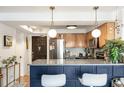 Updated kitchen with two tone cabinets, stainless steel appliances, and bar seating at 1833 N Williams St # 201, Denver, CO 80218