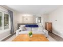 Bright living room with modern decor, a large window, and hardwood floors at 3841 W Quinn Pl, Denver, CO 80236