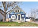 Charming blue two-story home with a lovely front porch and detached garage at 5103 Quitman St, Denver, CO 80212