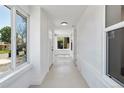 Bright hallway featuring white walls and ceilings and large windows, offering ample natural light at 4745 N Clay St, Denver, CO 80211