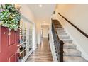Inviting entryway with hardwood floors, staircase, and decorative wreath on the door at 5038 Blue Lunar Ln, Castle Rock, CO 80104