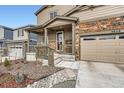 Inviting front porch with stone accents, a warm, welcoming entrance to this lovely home at 5038 Blue Lunar Ln, Castle Rock, CO 80104