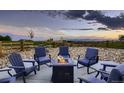 Outdoor patio with a fire pit and comfortable seating, perfect for enjoying the sunset at 38 Morgan Cir, Erie, CO 80516