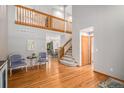 Spacious living area featuring hardwood floors, a vaulted ceiling, and an open staircase to the loft at 9640 Moss Rose Cir, Highlands Ranch, CO 80129
