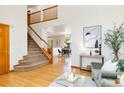 Open-concept living area with hardwood floors, staircase, and views of the dining room at 9546 High Cliffe St, Highlands Ranch, CO 80129