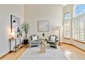 Inviting living room with hardwood floors, large windows, and stylish furniture at 9546 High Cliffe St, Highlands Ranch, CO 80129